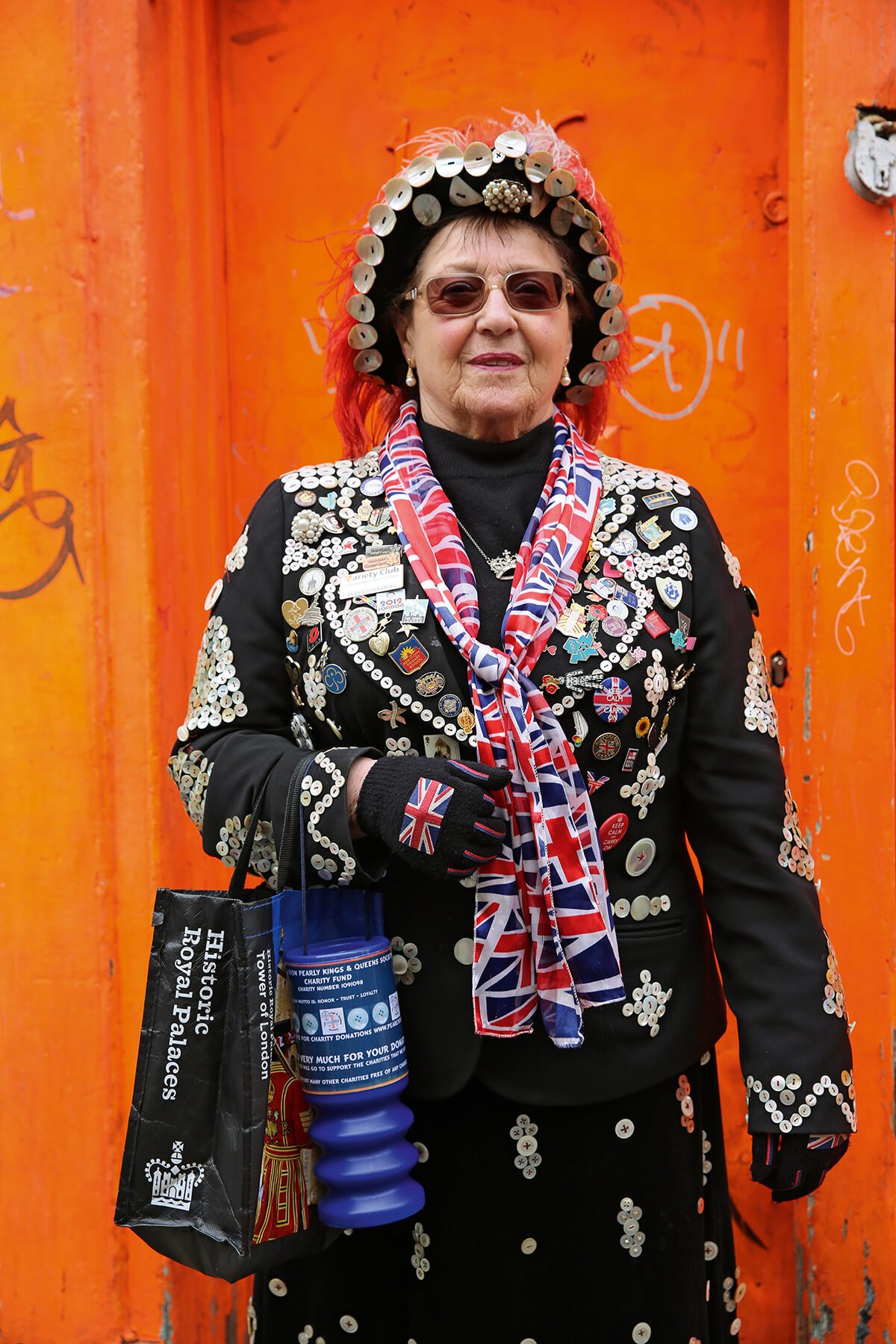 Pearly Queen Doreen Golding portrait in front of orange door by artist Maryam Eisler