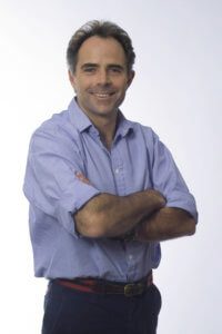 Colour portrait of Joss Kent standing with arms folded