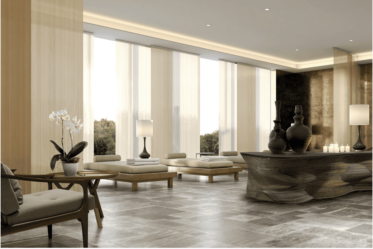 sleek contemporary interiors of spa relaxtion room with tiled floor and day beds