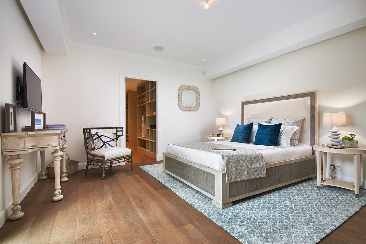 Luxury bedroom with double bed and white and blue furnishings