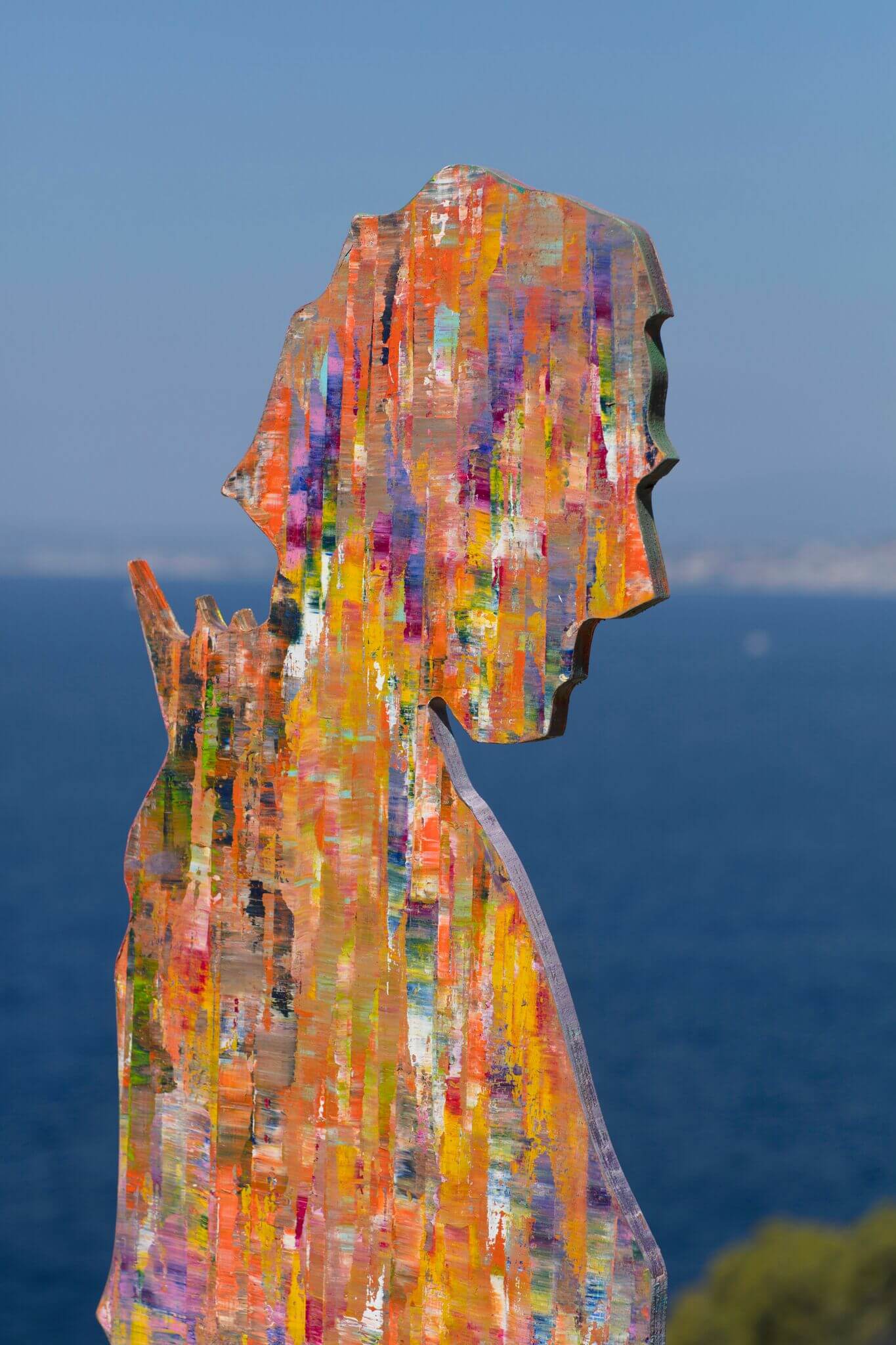 Detail image of sculpture of a man in bright painted colours