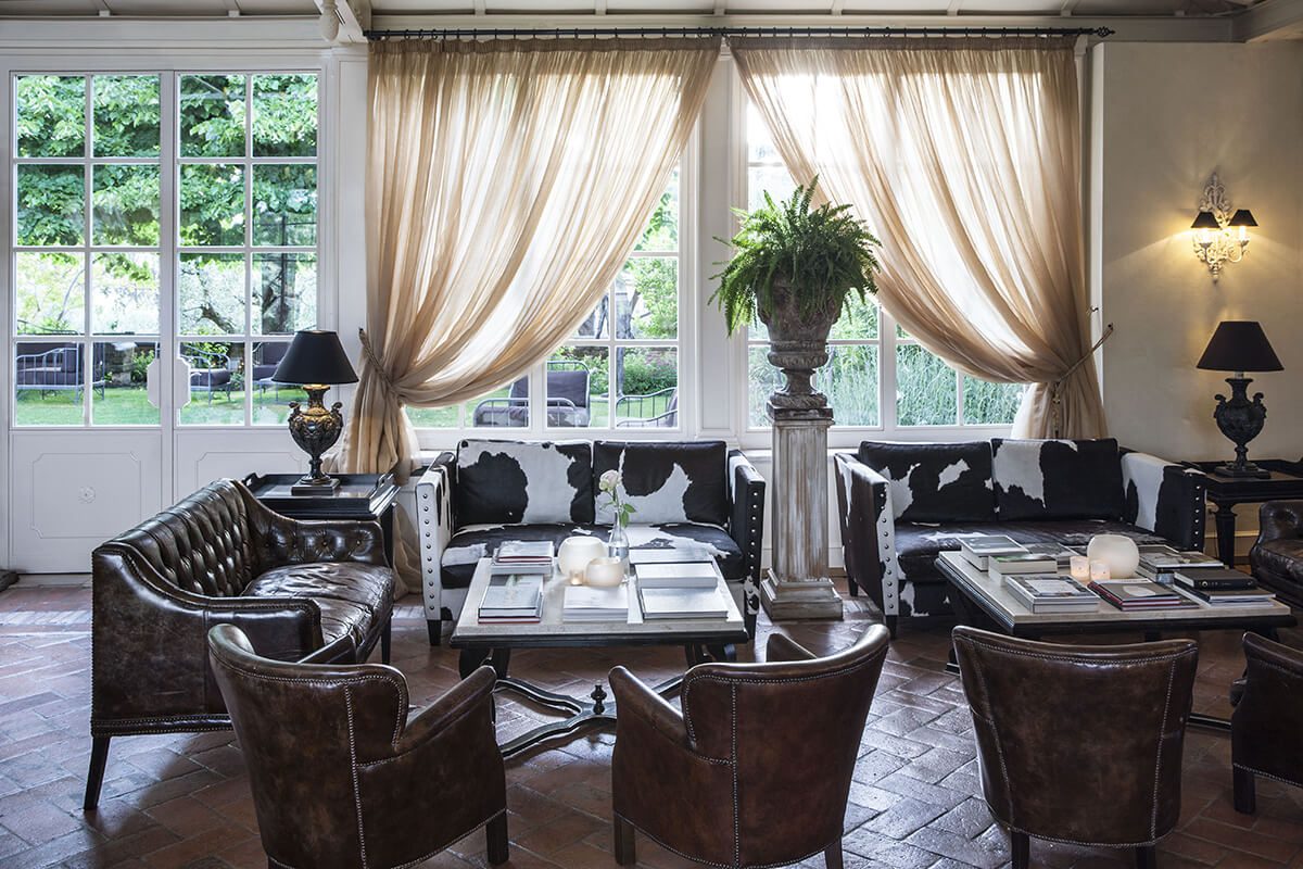 Luxury living room with sofas, armchairs and potted plants