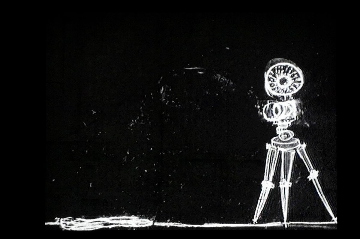 chalk drawing of tripod like machine walking along a chalk line on a black background