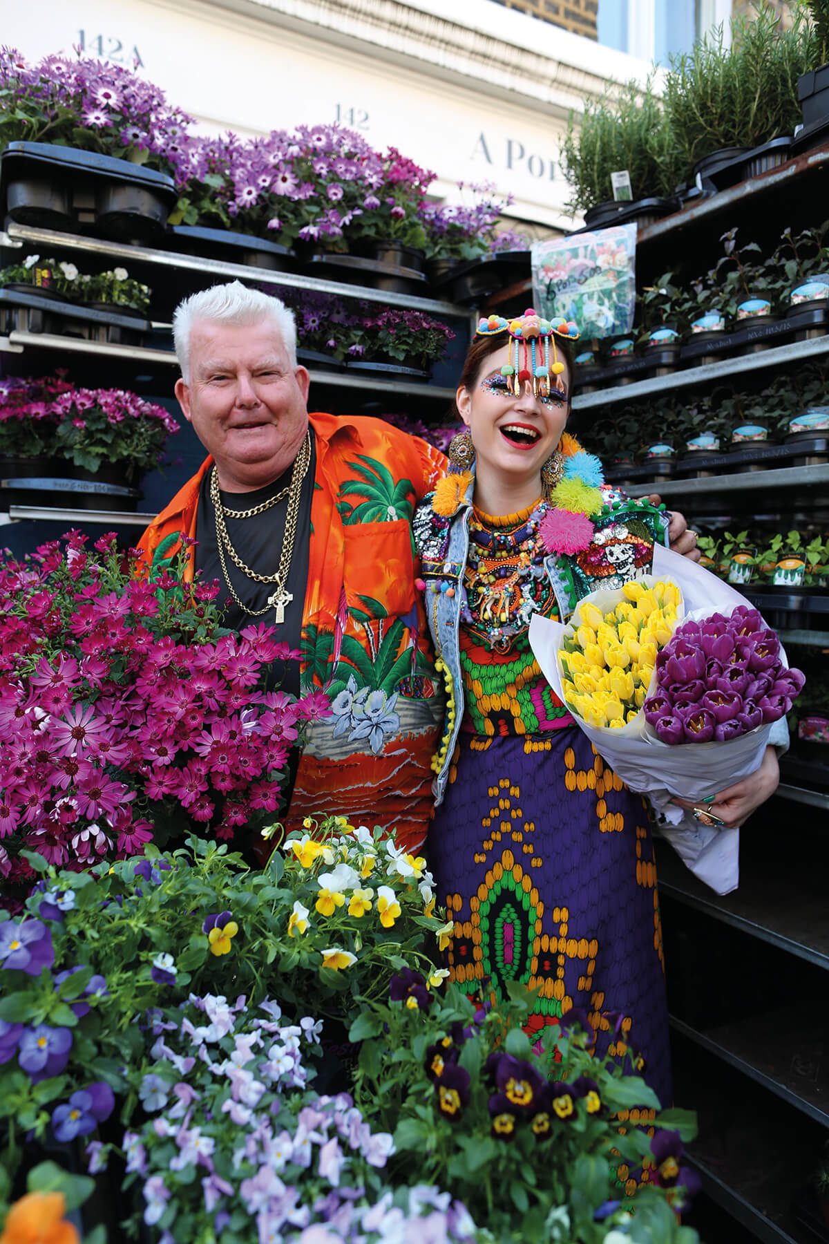 Designer Anne Sophie Cochevelou pictured in flower market holding a bunch of colourful flowers