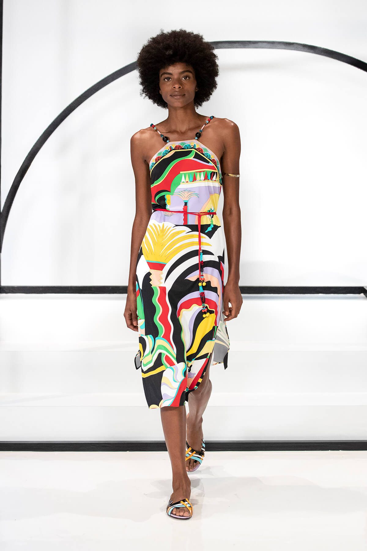 Model on catwalk wearing a colourful summer dress
