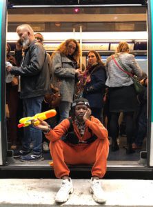 Image of man sitting on a metro doorway