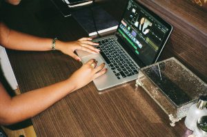 Derin Adetosoye editing a YouTube channel post