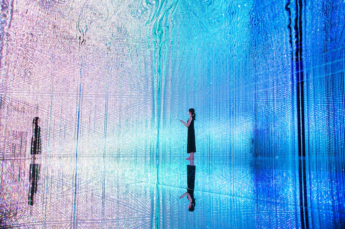 Immersive digital art installation with coloured lights surrounding a room