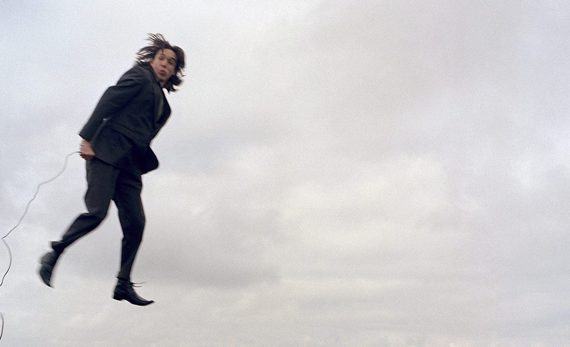 Tom Pope performance artist pictured floating in mid air