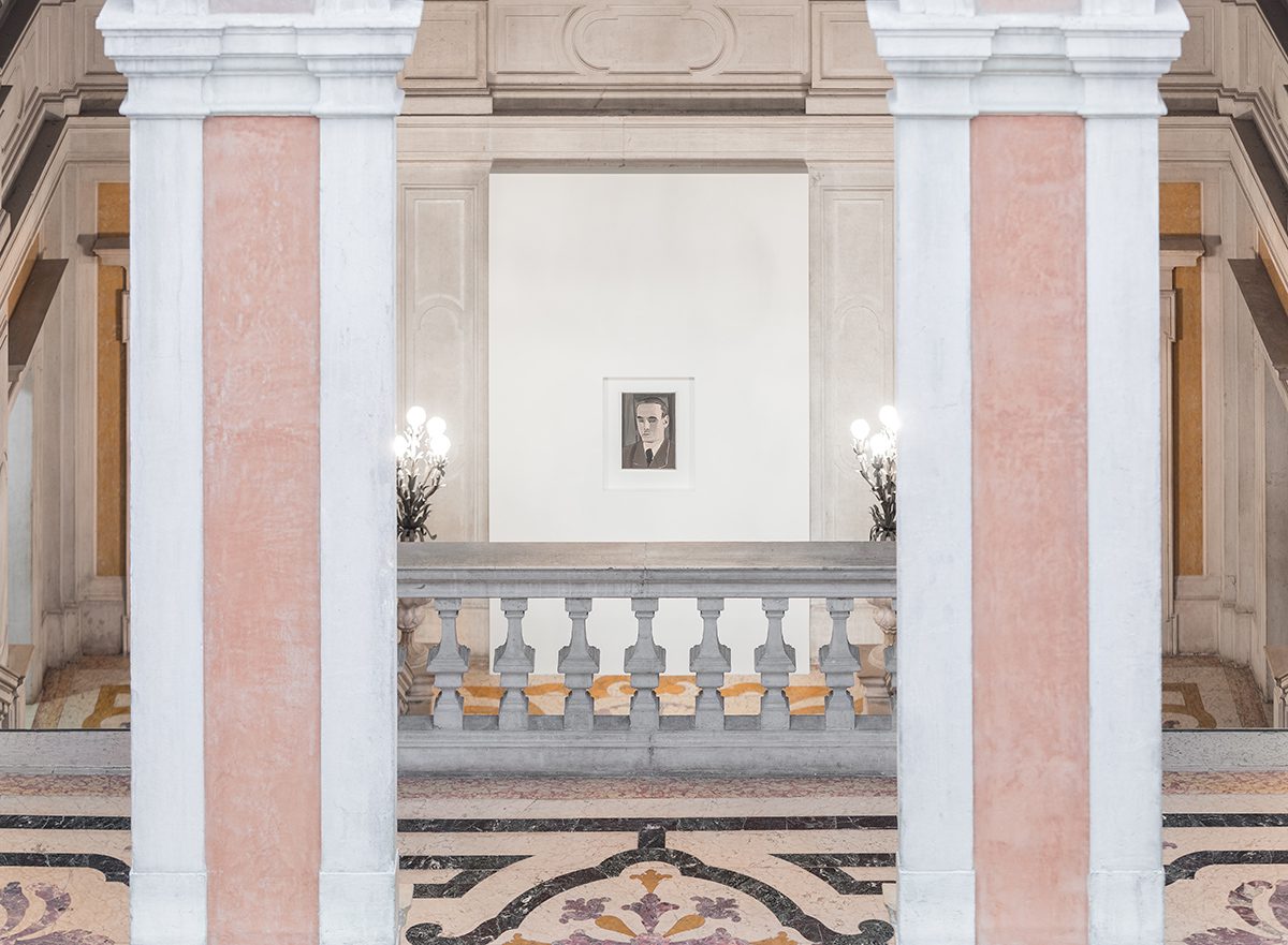 Installation shot of a Luc Tuymans exhibition with a small painting between two columns at the top of stairs