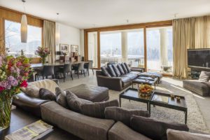 Luxurious open plan living area with alpine views from double windows