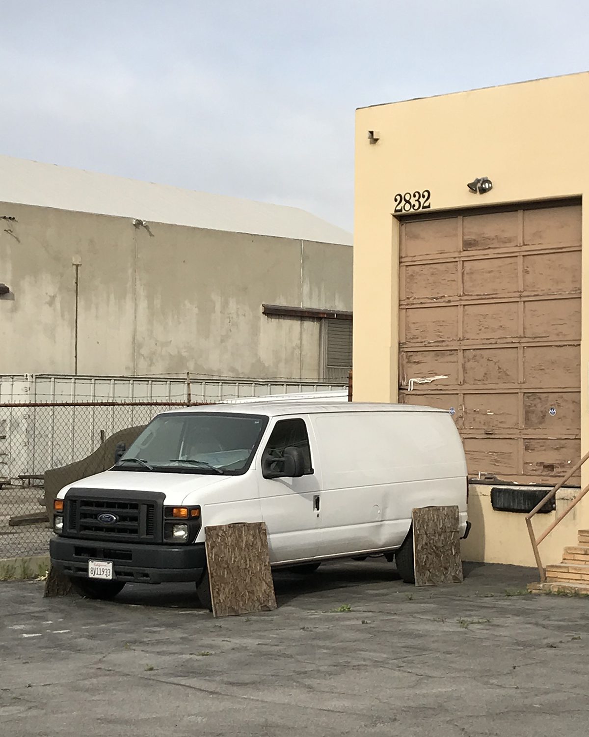 Surreal photograph of a white van without wheels