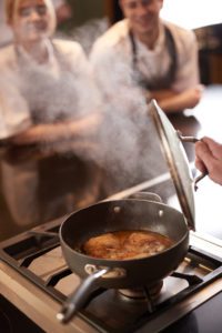 A pot of food simmering on hob