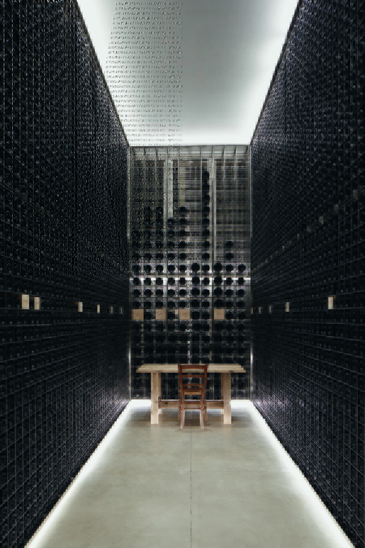 A slim wine cellar with bottles from floor to ceiling