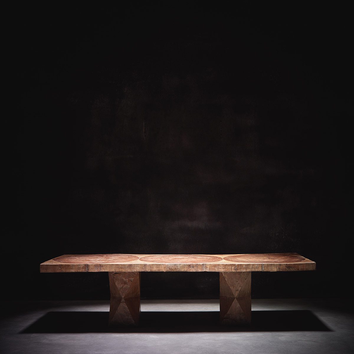 Low coffee table photographed under spotlight in a dark room