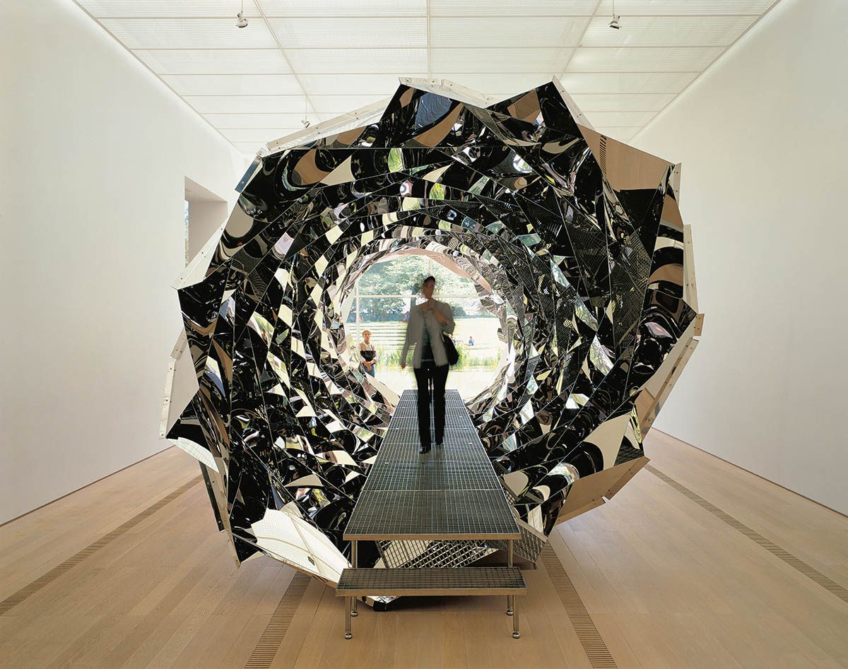 Silver spiral sculpture in an art gallery space