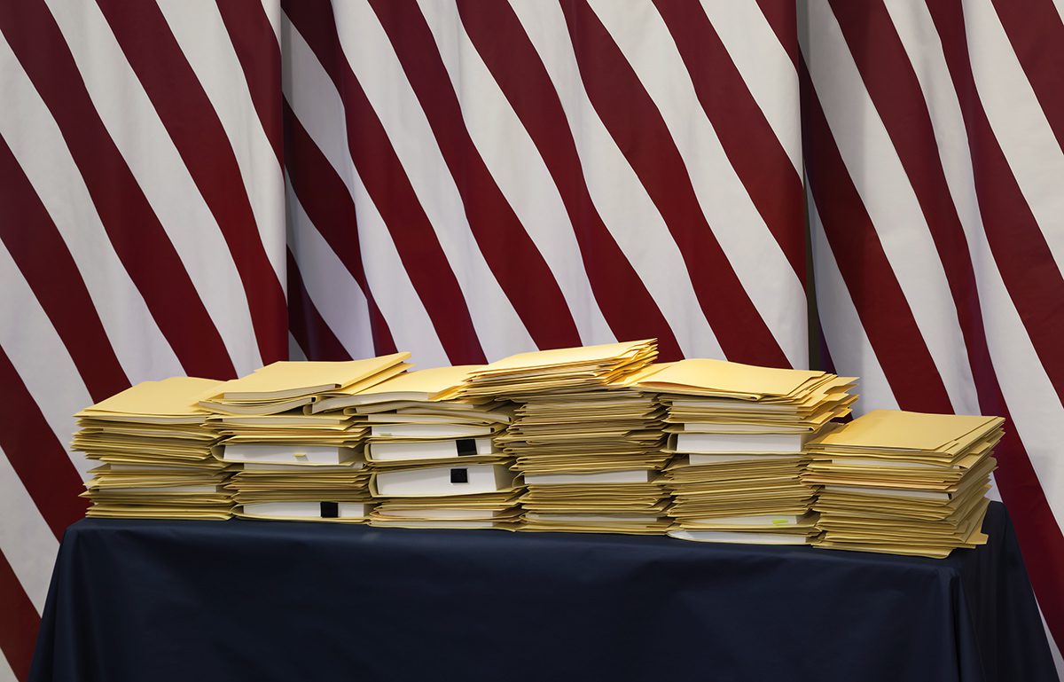 Stacks of folders photographed against a red and white background