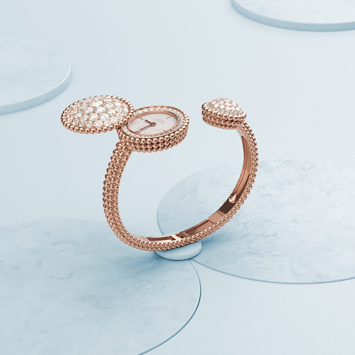 Diamond studded watch bracelet pictured on a pale blue background
