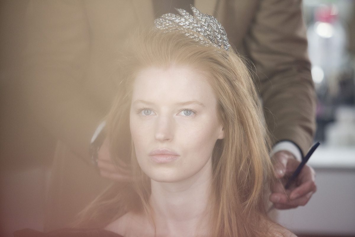 Backstage image of a model wearing a tiara