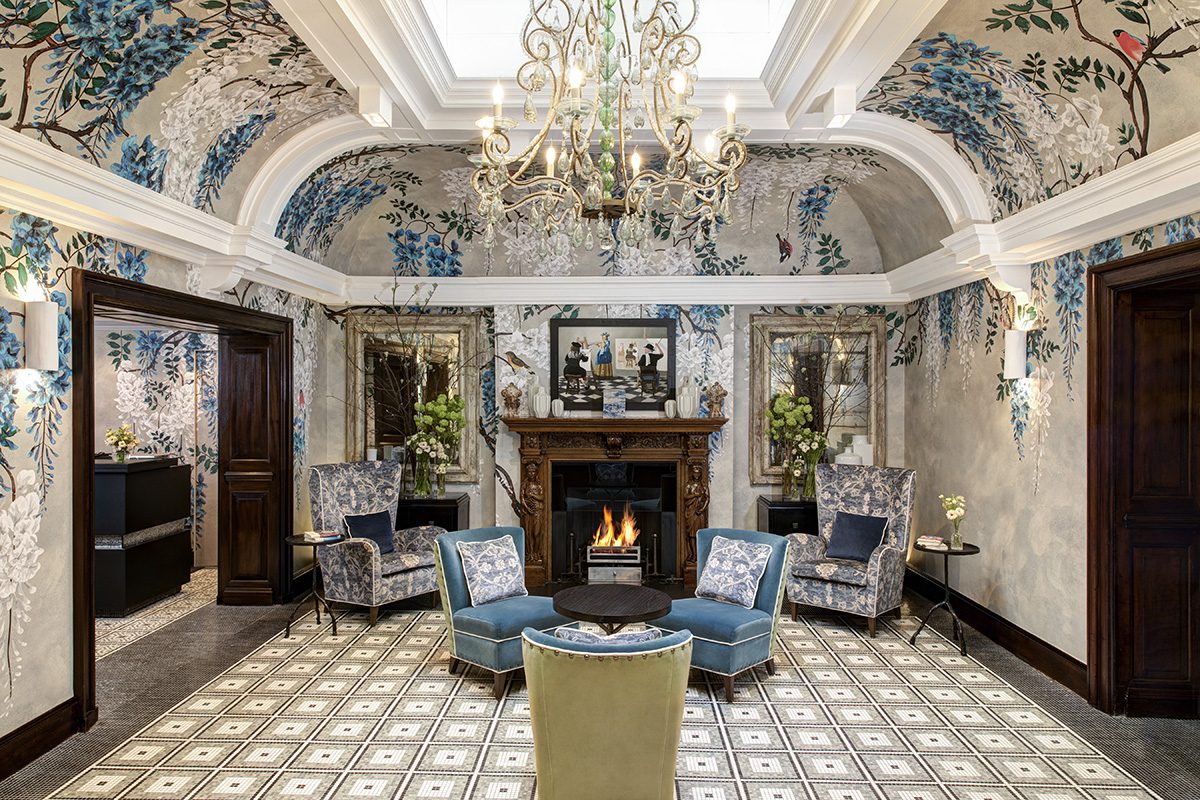 Luxury hotel interiors of a drawing room with painted walls and soft furnishings