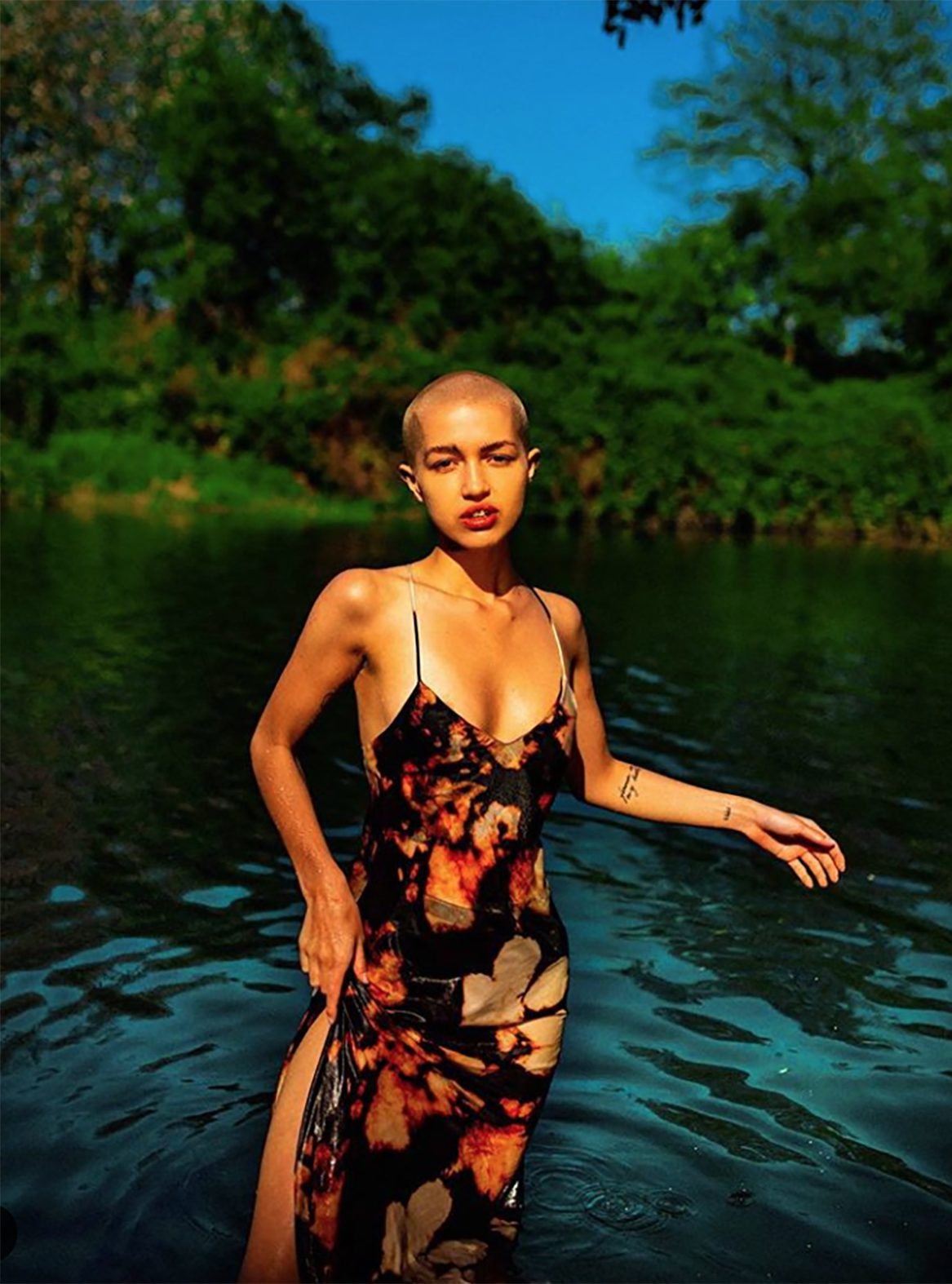 Emily O'Donnell walking through water in a dress