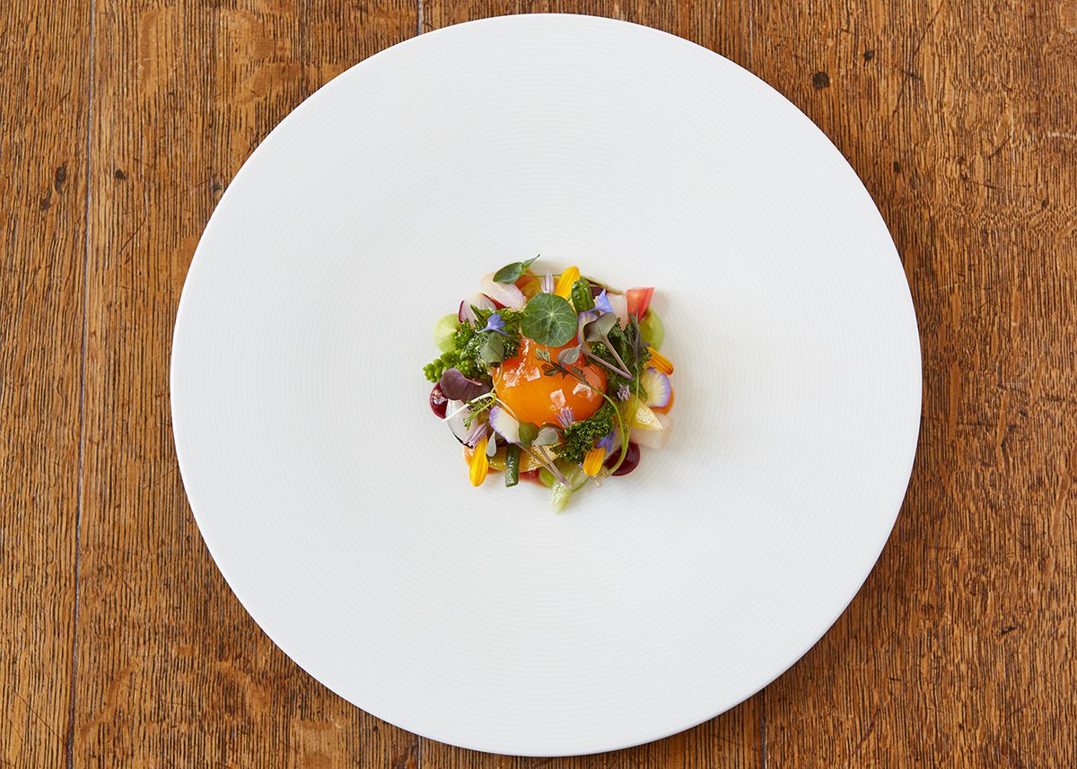 Luxury fine dining dish with flowers and egg yolk