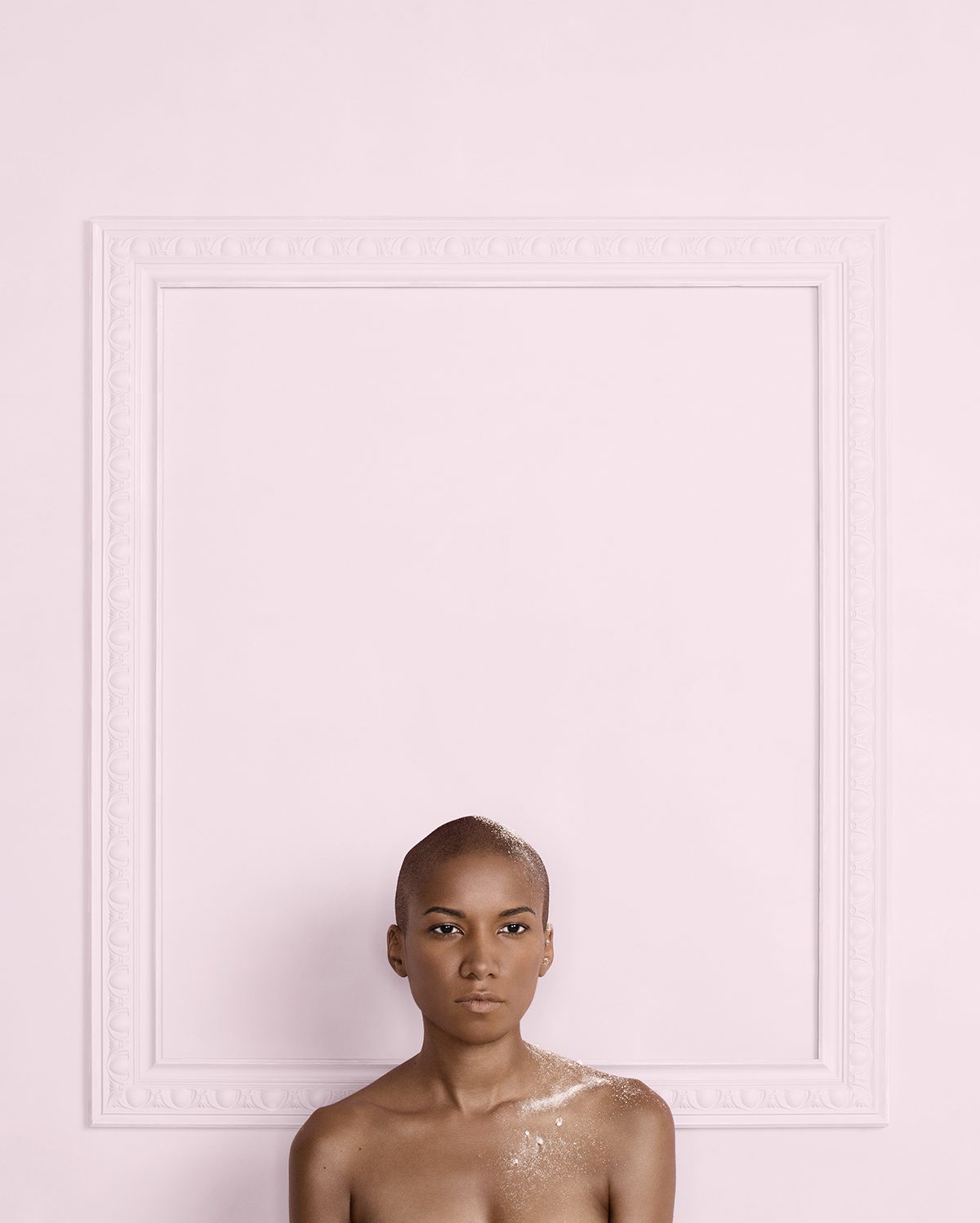 Portrait of a woman standing in front of a pink wall