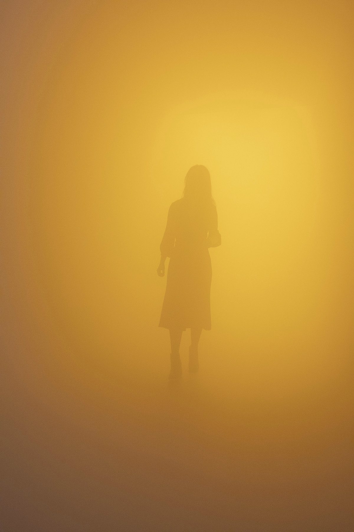 Figure emerging from yellow mist