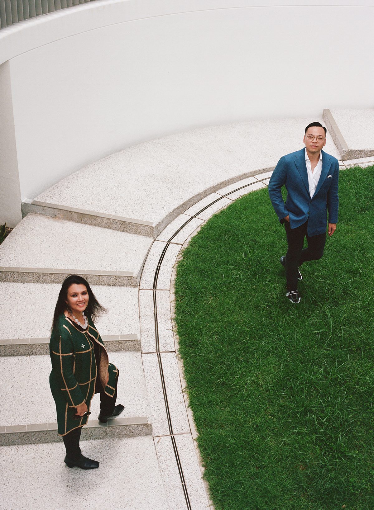 Man and woman standing on curved staricase