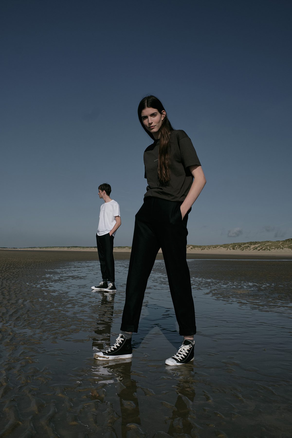 Models posing in casual clothes on beach