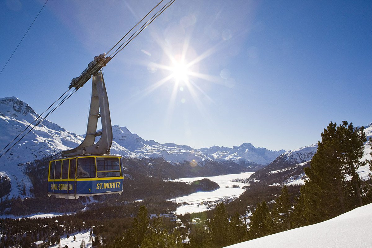 Cable car on the way up a snowy mountain side
