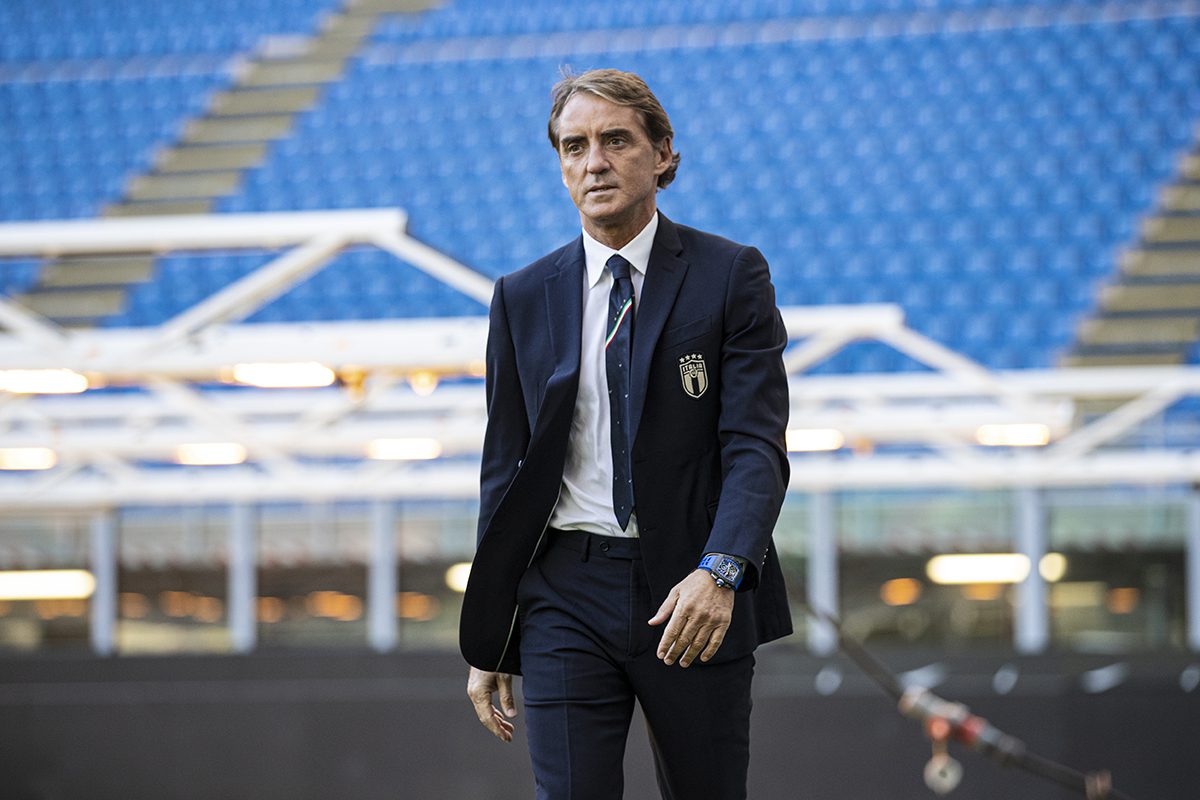 Man walking across stadium wearing watch