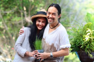 Portrait of man and woman standing in natural setting