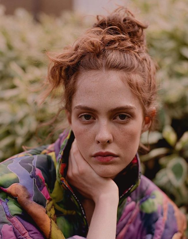 Portrait of young woman with red hair