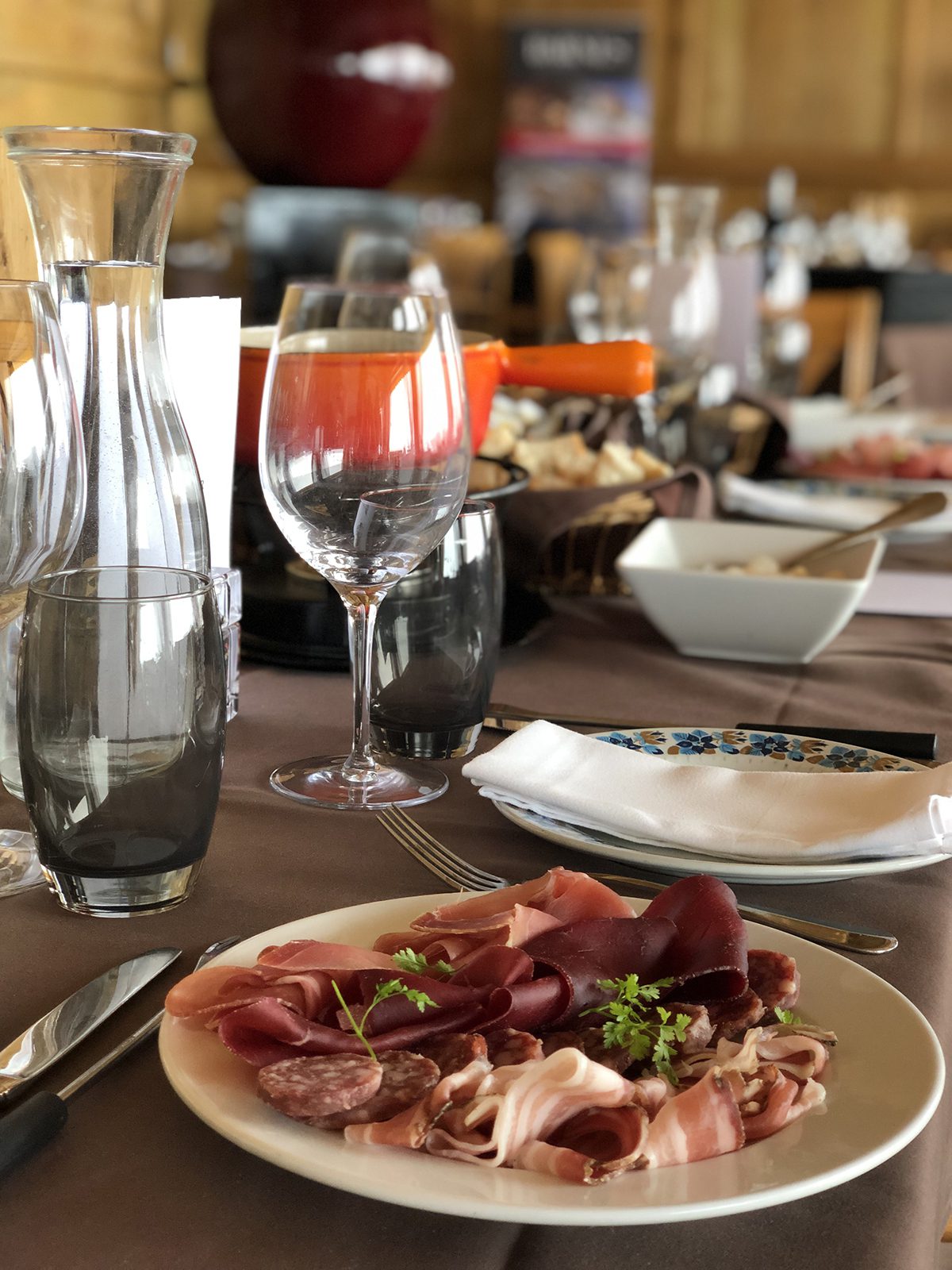 Detail image of a table with wine and hams