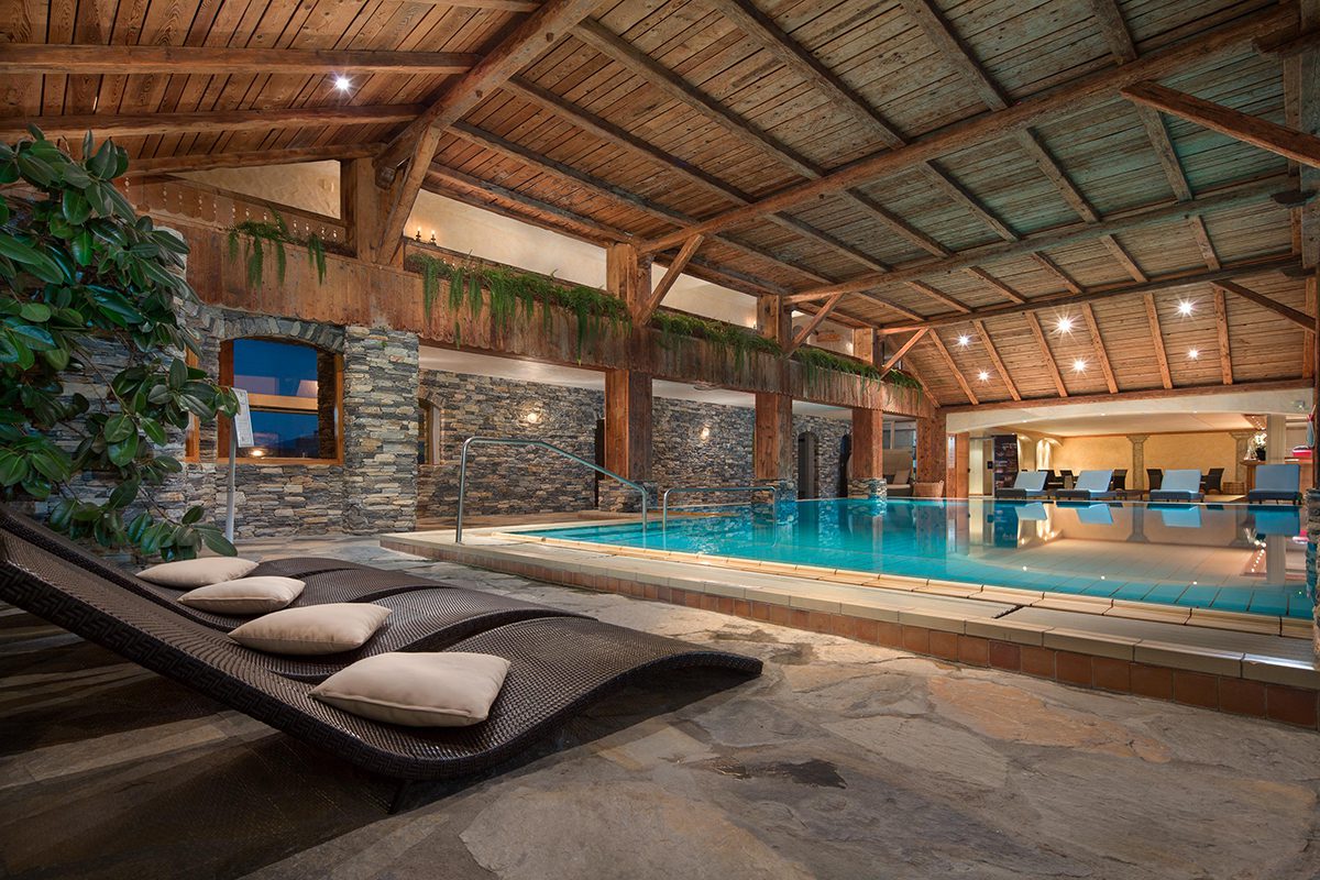 Luxurious indoor swimming pool with loungers