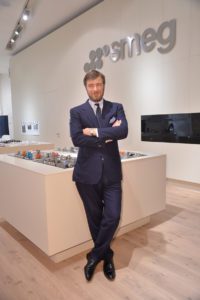 Man in suit standing in kitchen appliance showroom