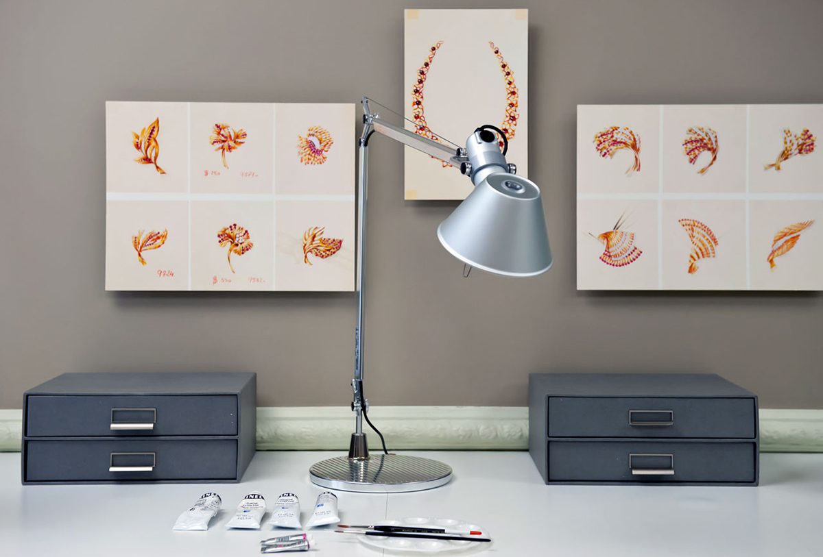 Artist desk with lamp, paintings and paints