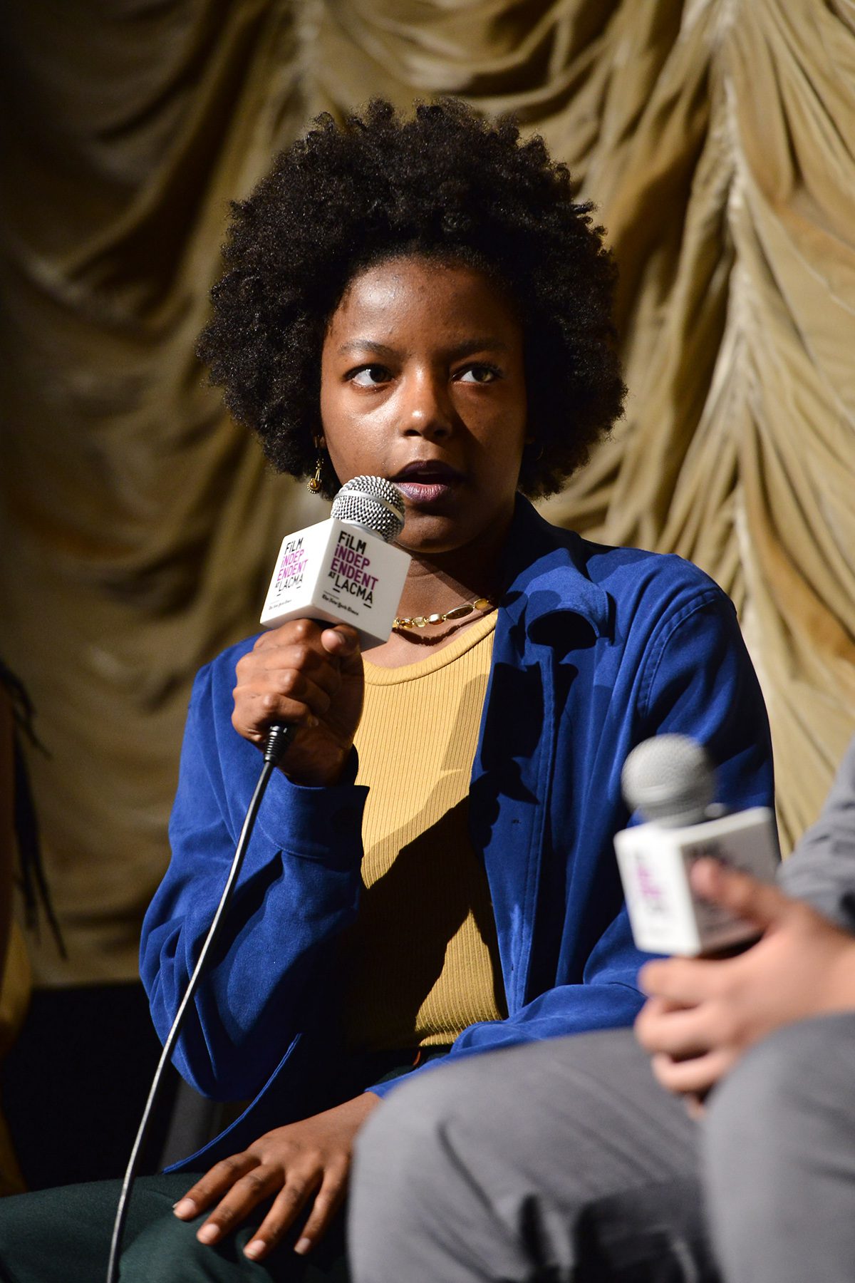 Woman speaking into microphone