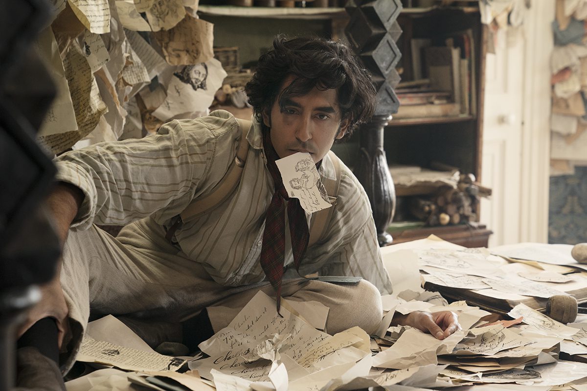 Man in office with paper in his mouth