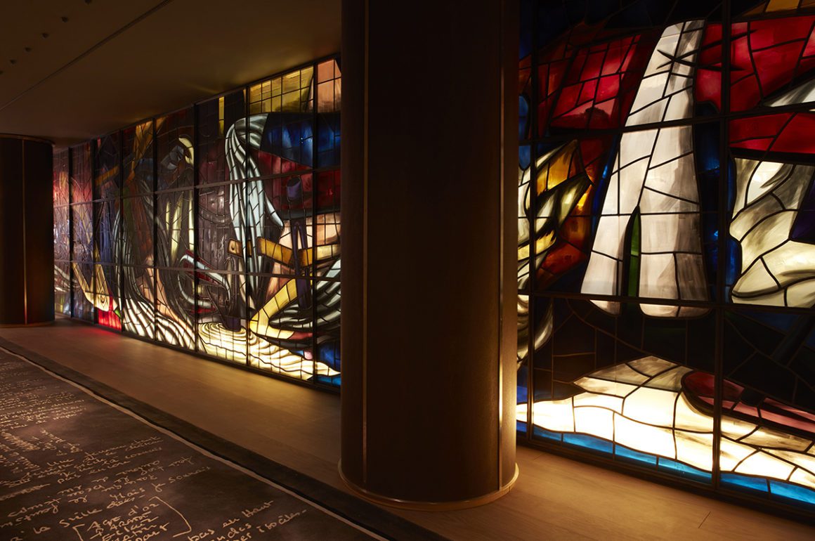Stainglass windows lining a corridor