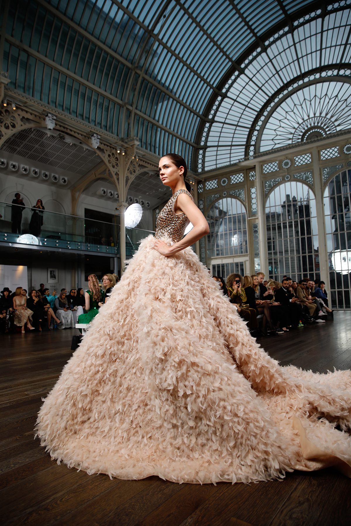 Model wearing maximalist dress on catwalk