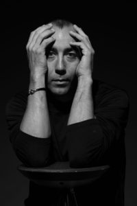 Monochrome portrait of man holding his head