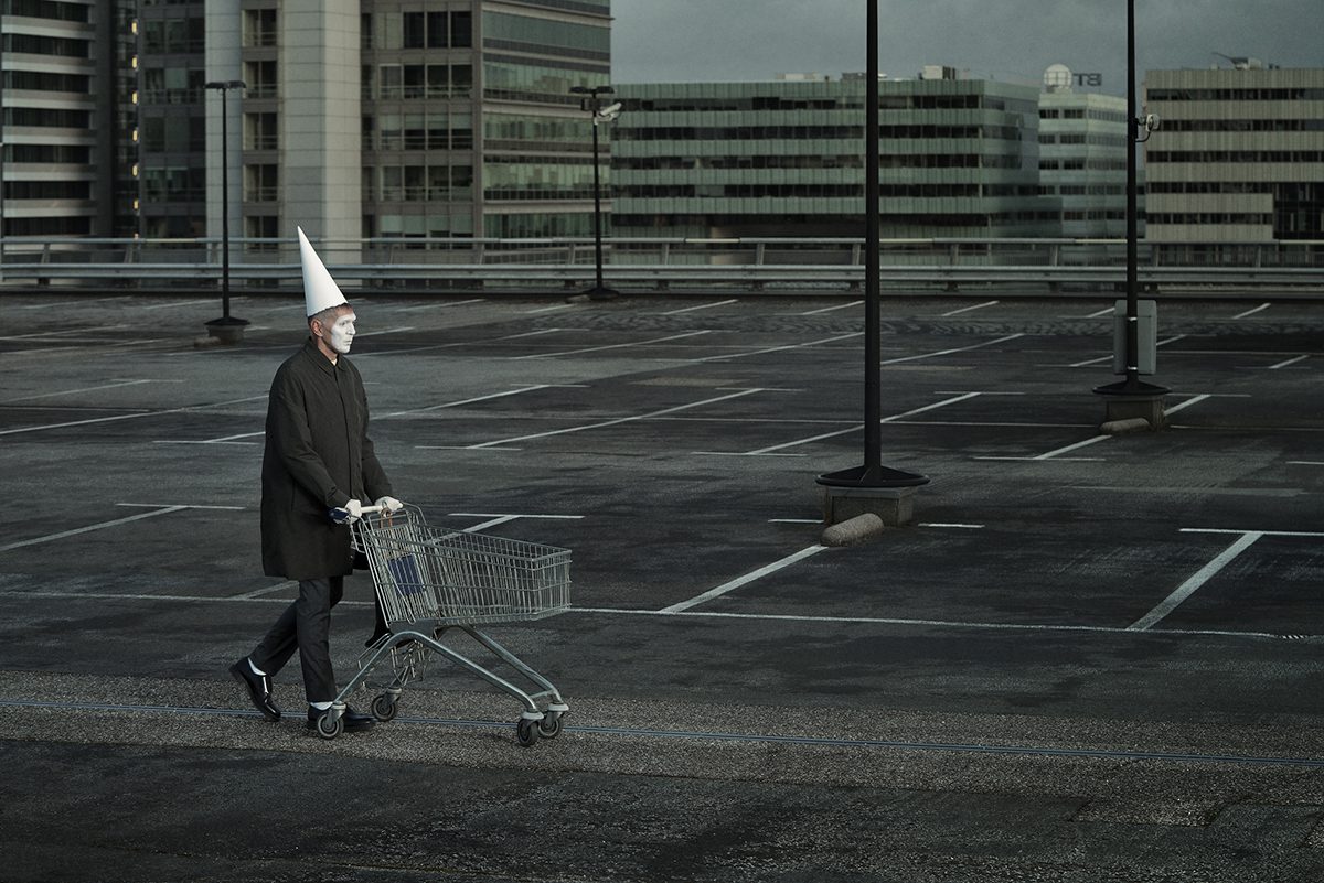 Clown pushing trolley