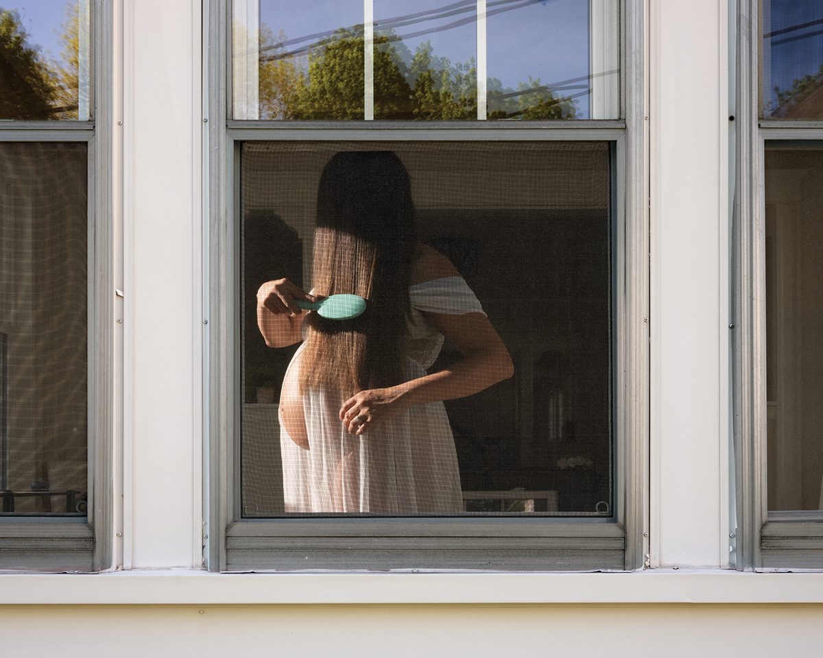 Pregnant woman brushing hair