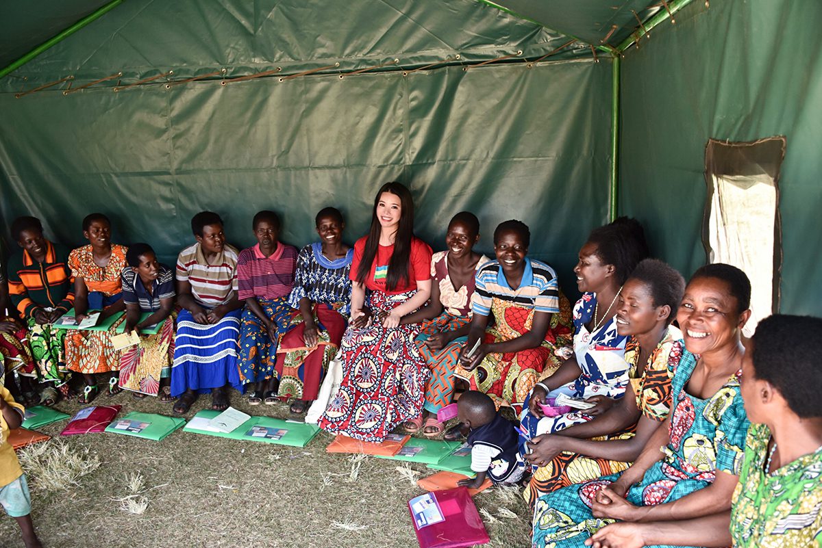 woman sitting amongst children