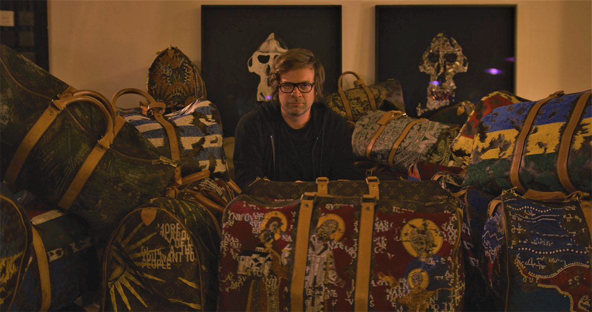 man sitting with bags