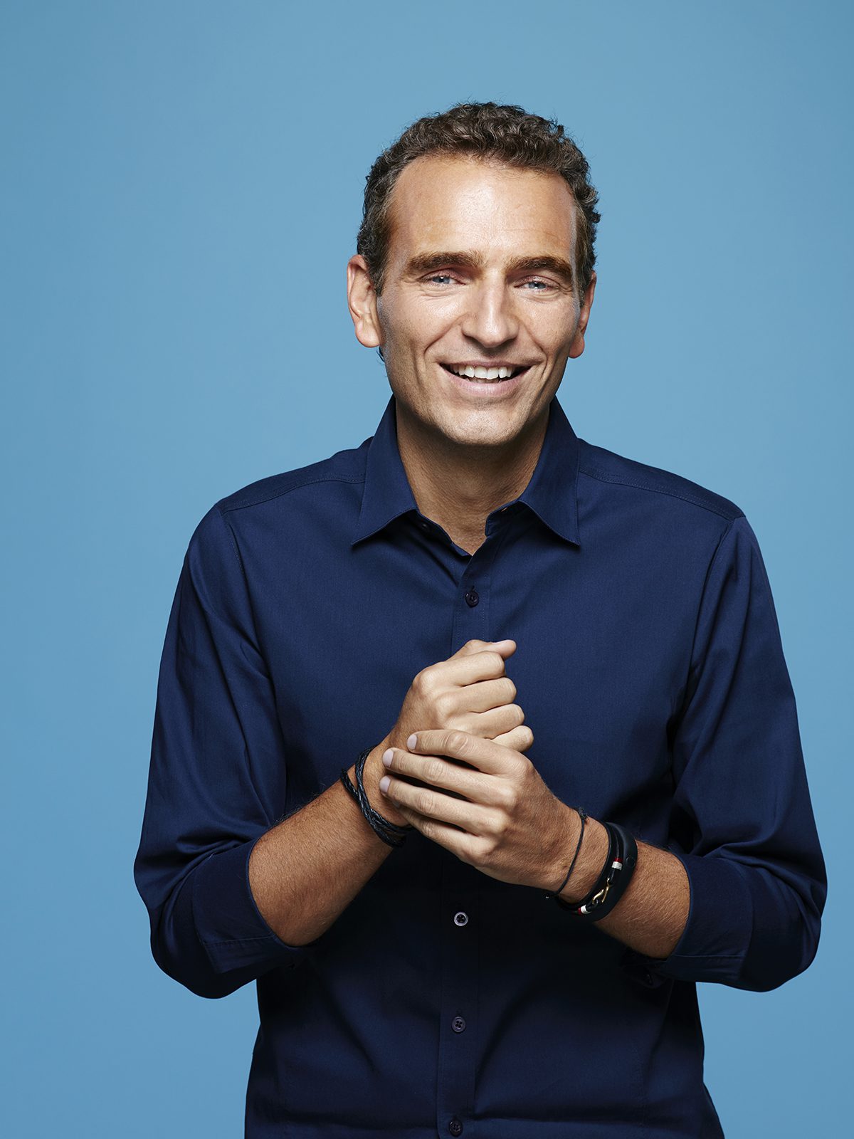 Headshot of man in blue shirt