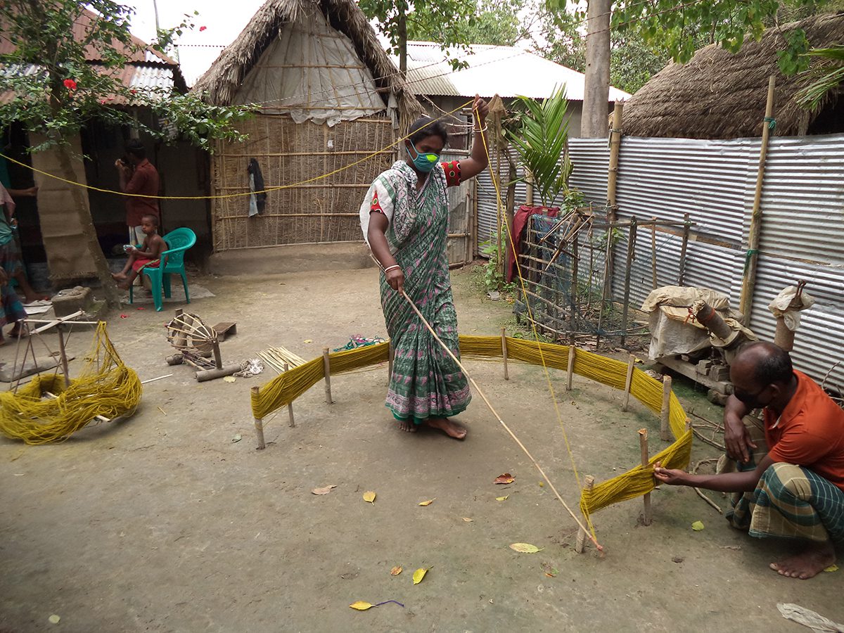 woman weaving in a village