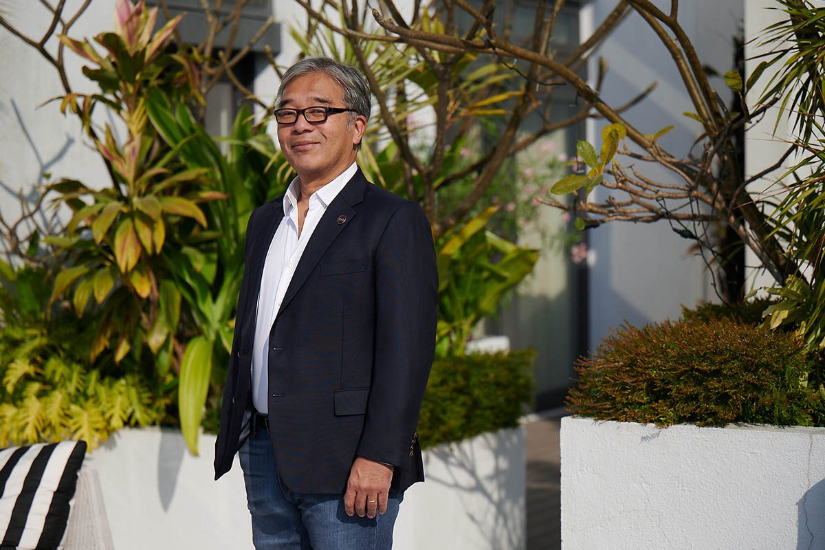 James Chen standing in front of plants